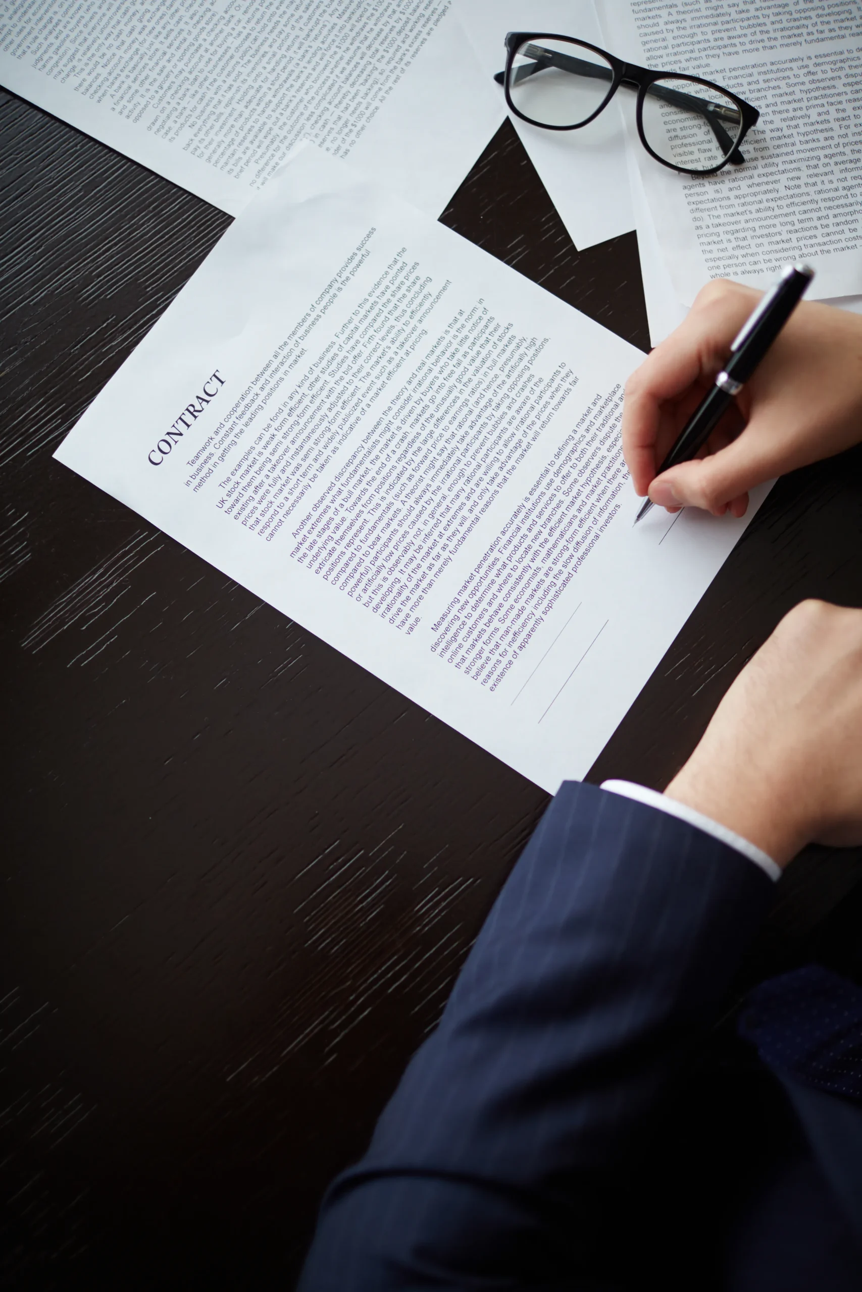 Close-up of a businessman signing a contract to finalize their SAM Registration.