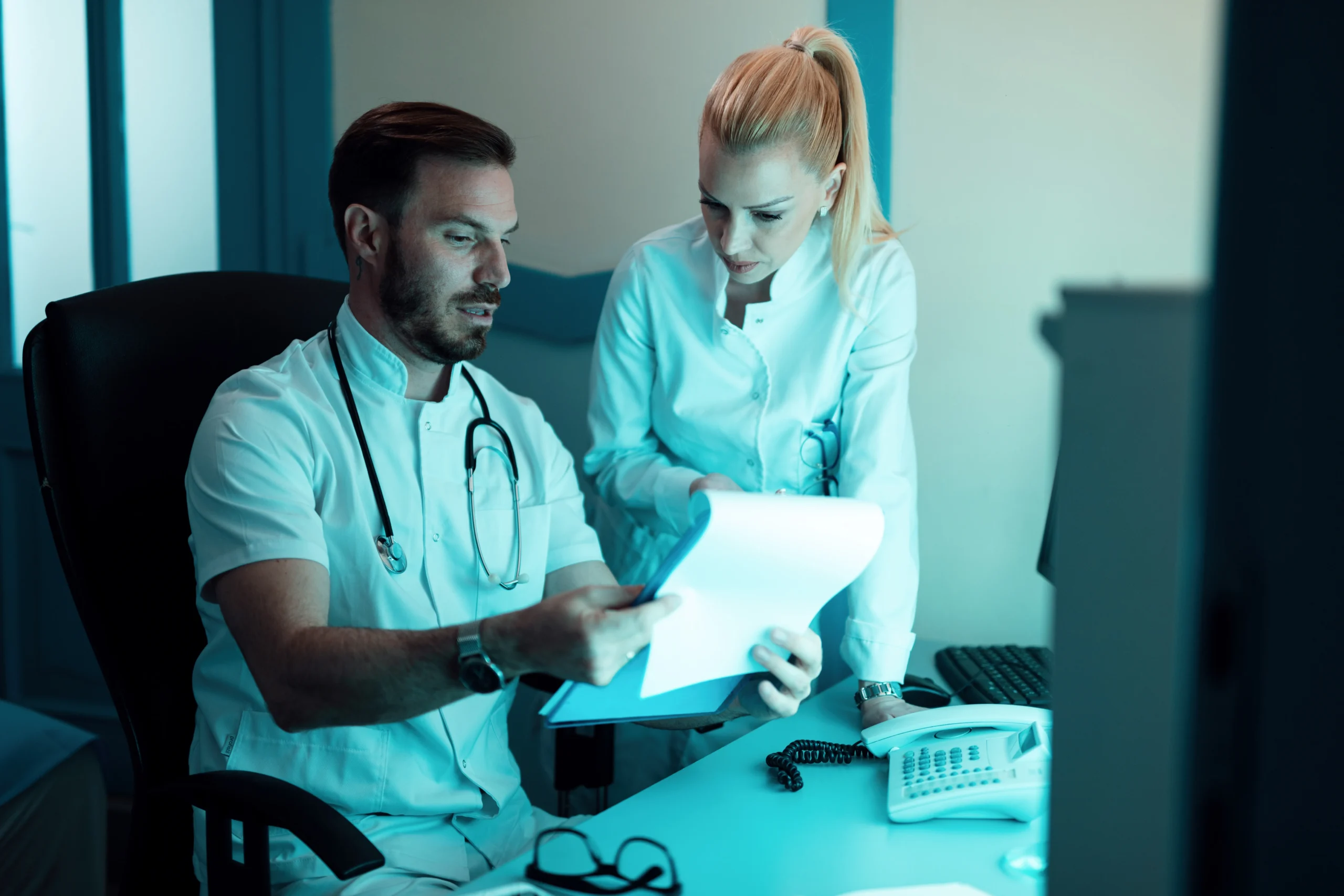 Medical staff reviewing provider credentials together to complete NPI verification.