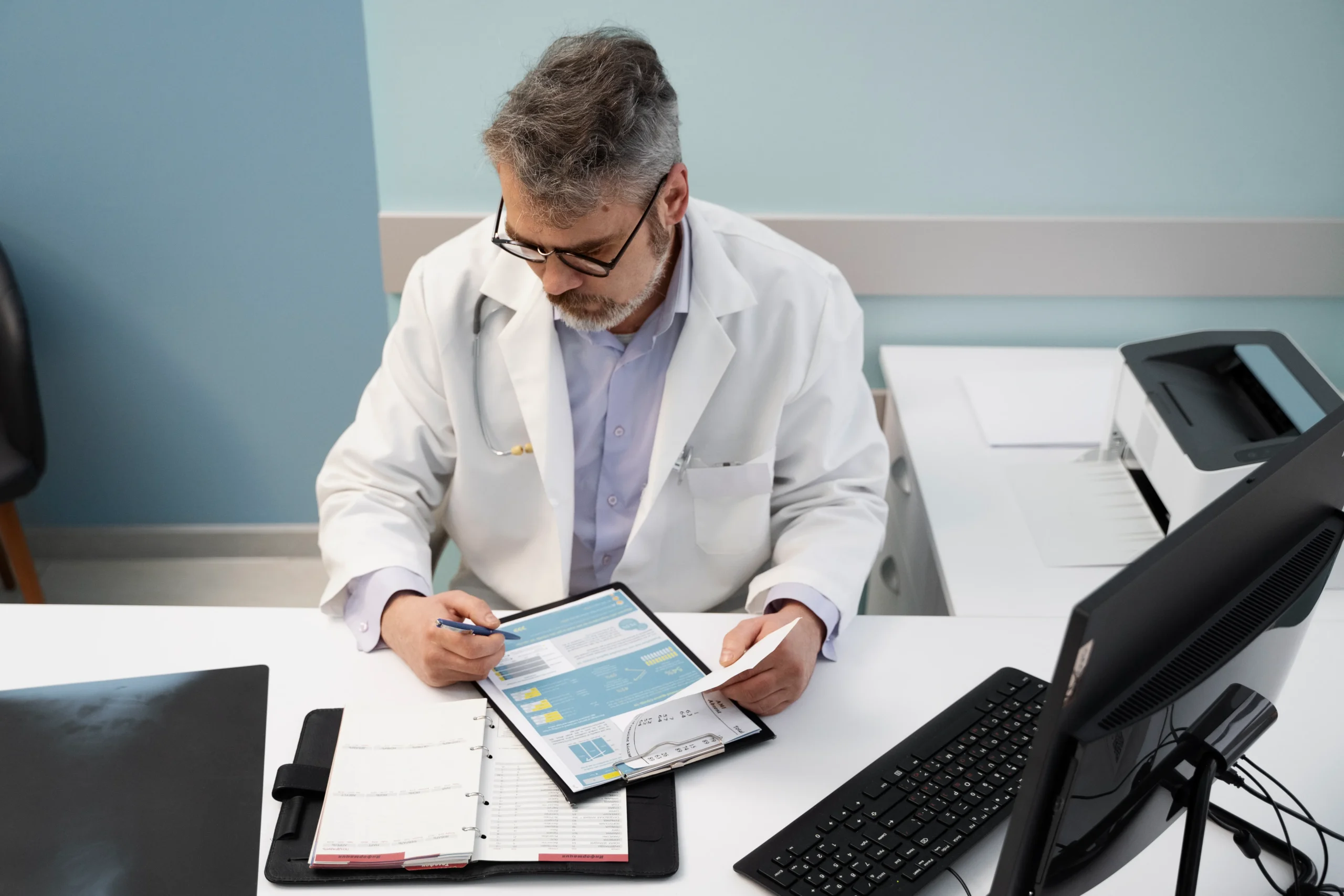 Senior physician auditing patient files and facility documentation during compliance screening.