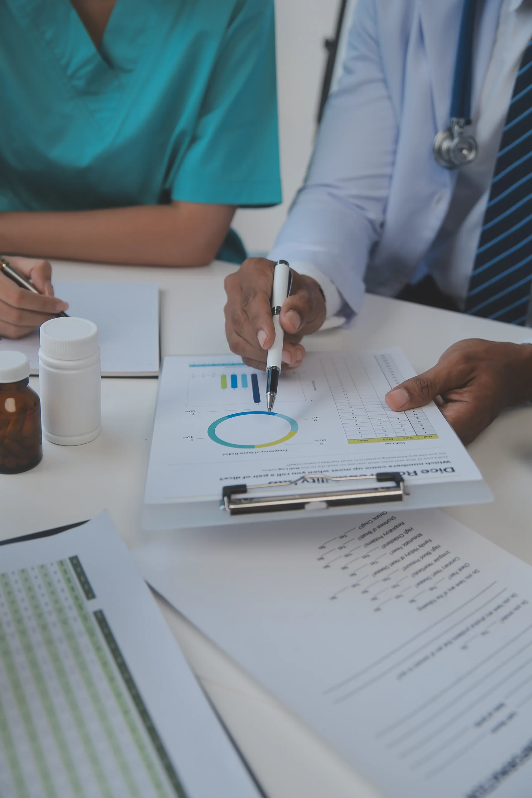 Healthcare personnel reviewing medical logs and audit reports during healthcare compliance screening.
