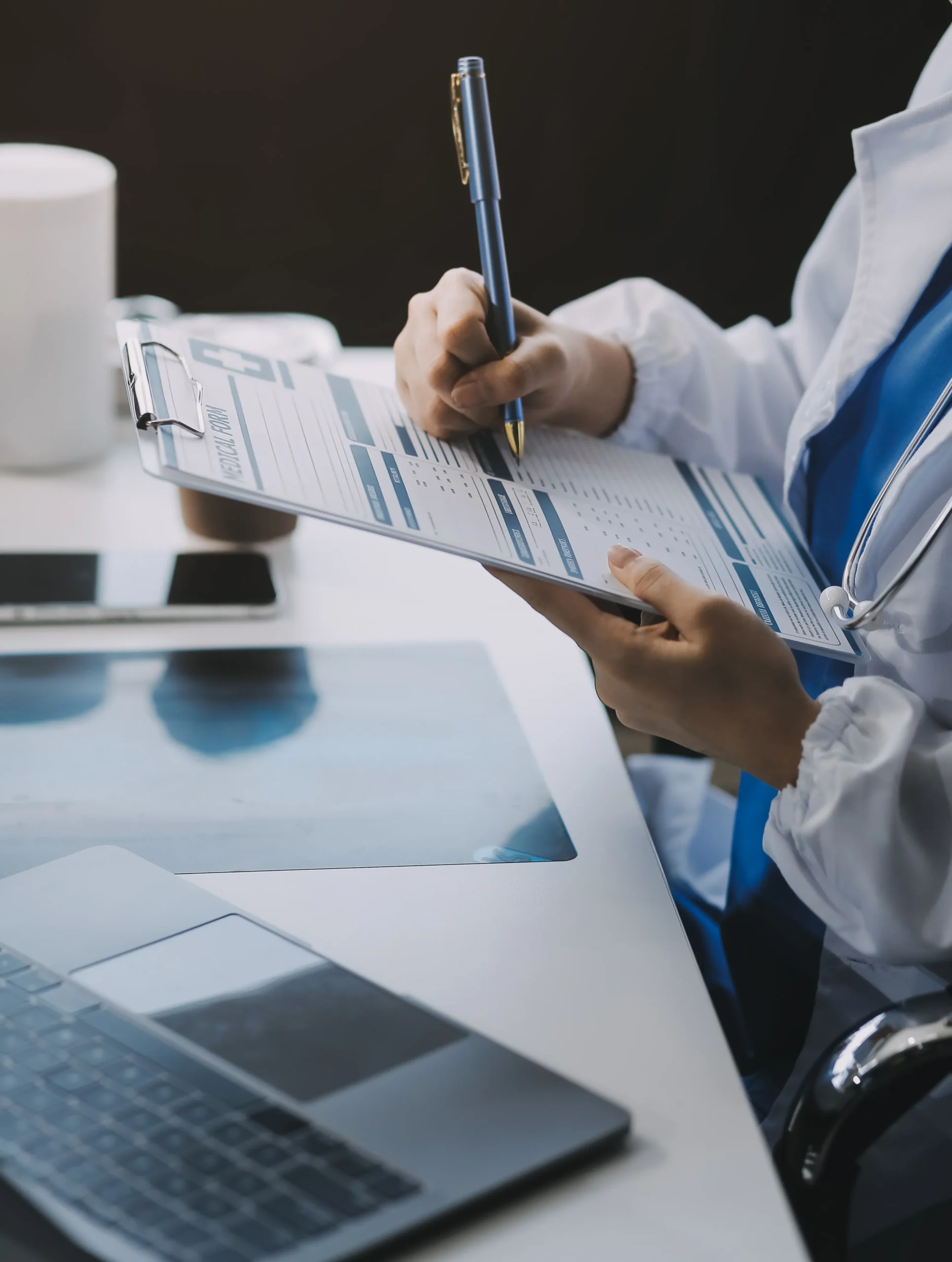 Healthcare administrator auditing physical credentialing records during healthcare compliance screening.